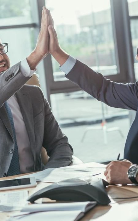 stock-photo-happy-business-people-giving-high-five-meeting-modern-office